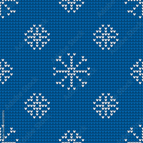 Seamless knitting pattern with snowflakes is on the blue background. Save with the Clipping Mask.