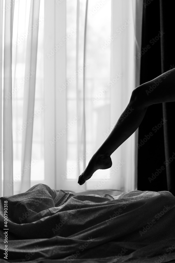 silhouette in front of the window. bride in puts on a wedding dress. silhouette in front of the window. bride in puts on a wedding dress.