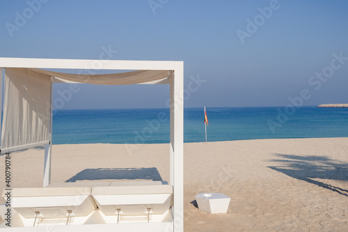 Relaxing empty beach with sun bed  sea landscape. Summer vacation travel holiday concept.