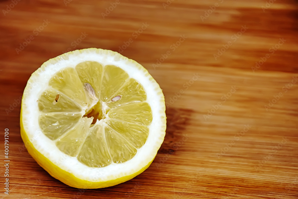 lemon half sliced on a wooden cutting board. lemon half sliced on a wooden cutting board.