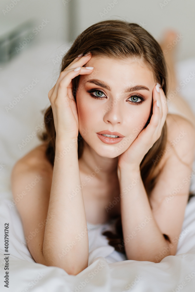 close up. portrait of beautiful woman with long hair in underwear lying on bed. close up. portrait of beautiful woman with long hair in underwear lying on bed.