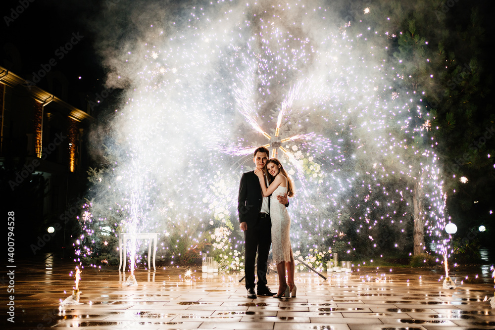 bride and groom are standing in the hallway of the fountains of the fireworks bride and groom are standing in the hallway of the fountains of the fireworks