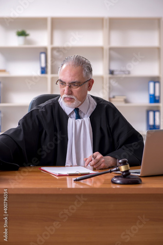 Old male judge working in courthouse