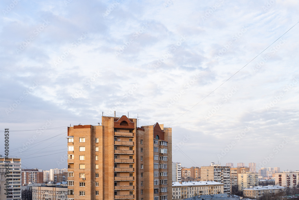 blue sky with gray clouds over residential district in Moscow city in winter morning