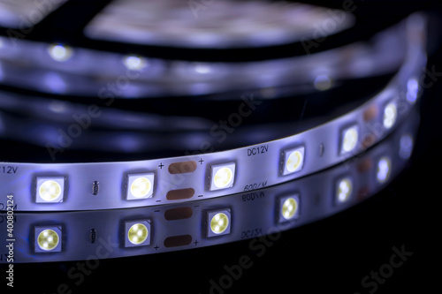 LED strip light macro shot on a shiny black surface photo