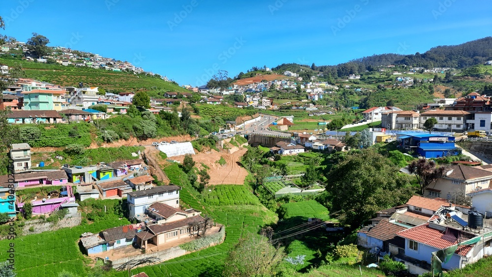 beautiful road side view of hill mountain landfall village house town with blue sky clouds background
