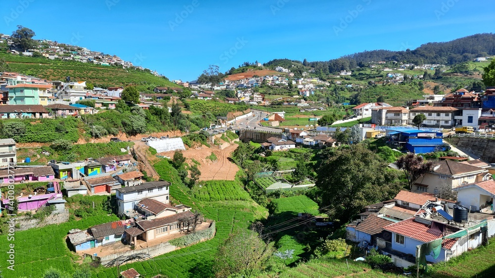 beautiful road side view of hill mountain landfall village house town with blue sky clouds background