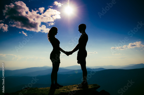 A guy and a girl look at each other at a height