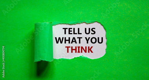 Tell us what you think symbol. Words 'tell us what you think' appearing behind torn green paper. Business and 'tell us what you think' concept. Copy space.