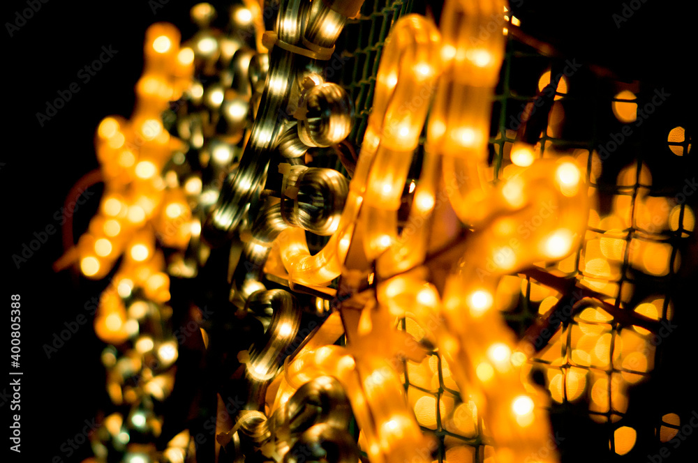 Christmas garland of yellow color close-up in the dark - obrazy, fototapety, plakaty 