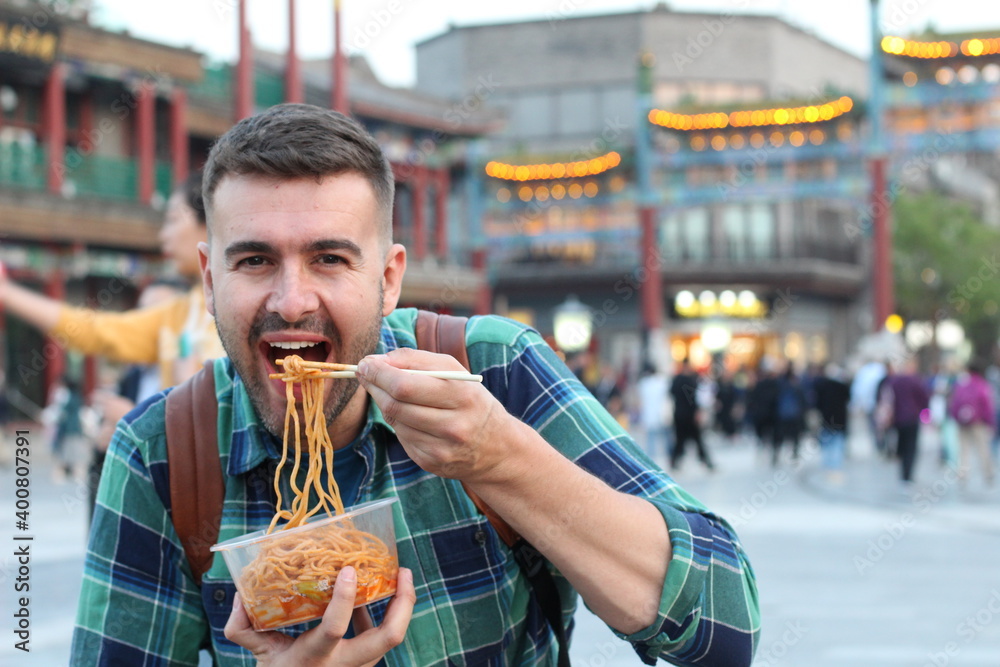 Man enjoying Asian street food 