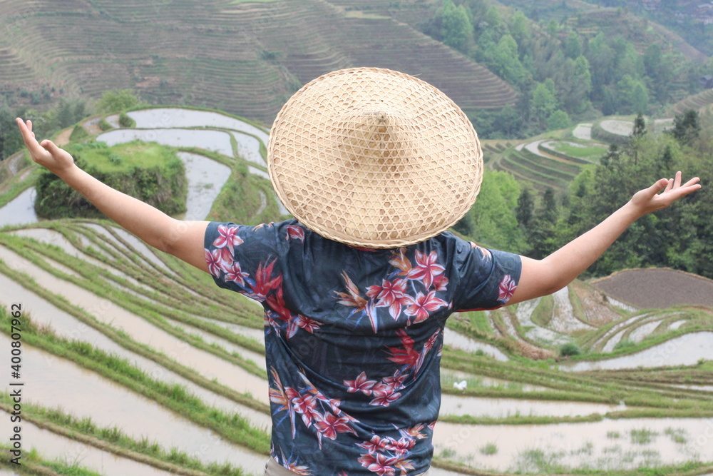 Fototapeta premium Man working in traditional Asian rice fields
