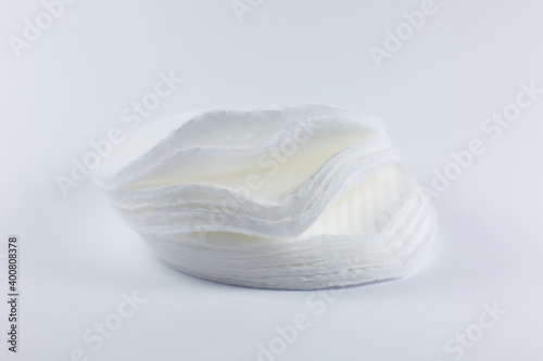 White cotton sponges on white background. Close up photo. Beauty, medicine and cosmetics procedures.