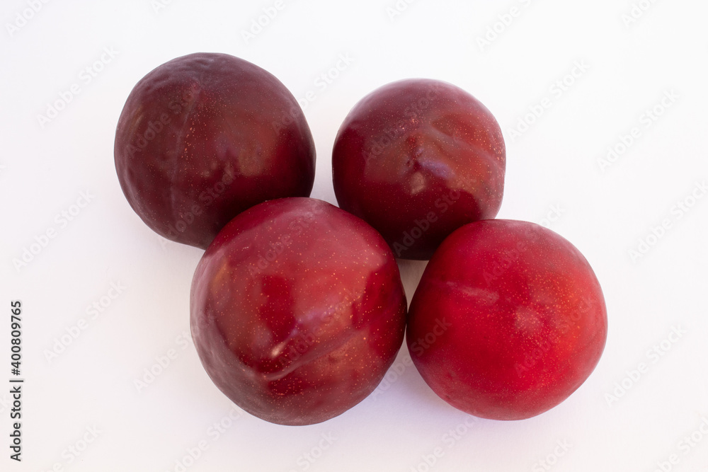Delicious red plums on white background