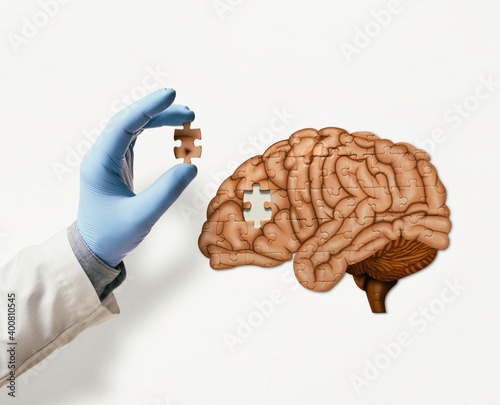 Puzzle with illustration of human brain and doctor hand with the missing piece of puzzle. Brain treatment concept. photo