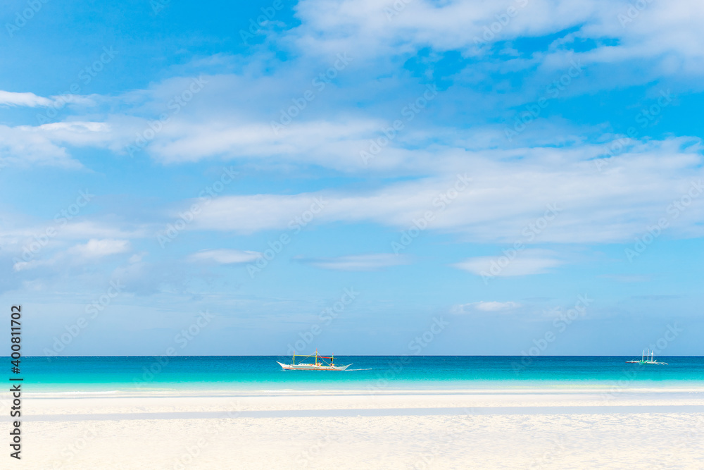 Tropical beach and beautiful sea with boats. Blue sky with clouds in the background. Tropical beach and beautiful sea with boats. Blue sky with clouds in the background.