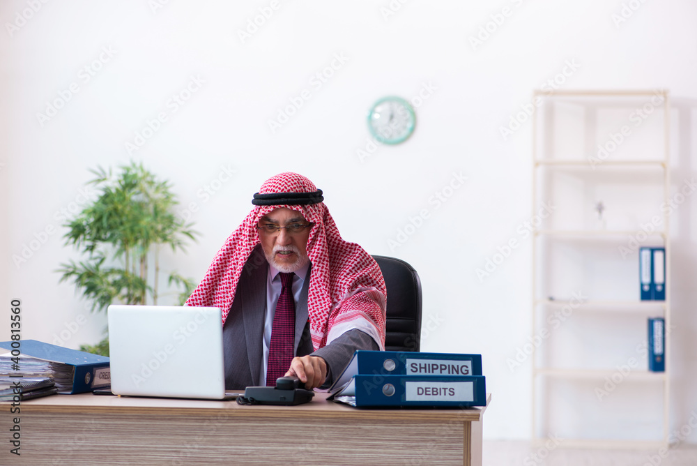 Male arab bookkeeper extremely tired with an excessive work