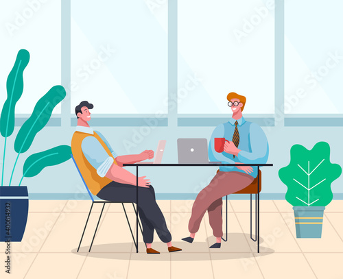 Businessmen dressed in formal clothes are sitting at the table with laptops and talking. Office workers discussing matters. Business meeting and consideration of working issues. Friendly team work