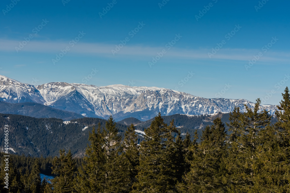 high mountains with snow and blue sky while hiking
