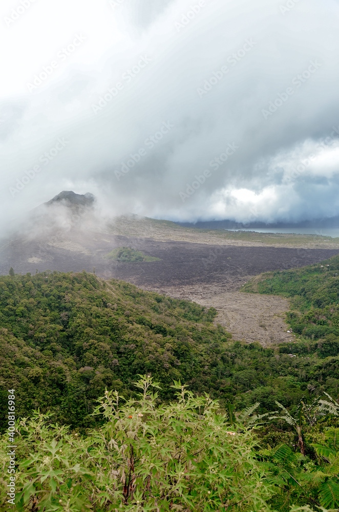 Gunung Batur is active volcano in the tropical island of Bali. The height of the volcano is 1717 meters Gunung Batur is active volcano in the tropical island of Bali. The height of the volcano is 1717 meters