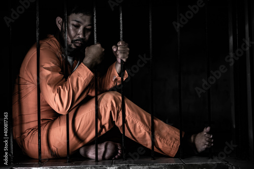 Fotografia Asian man desperate at the iron prison,prisoner concept,thailand people,Hope to