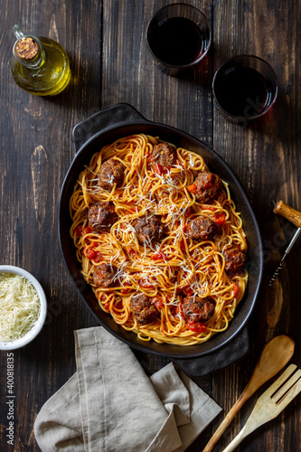 Meatballs with spaghetti, tomato sauce and parmesan cheese. Italian cuisine.
