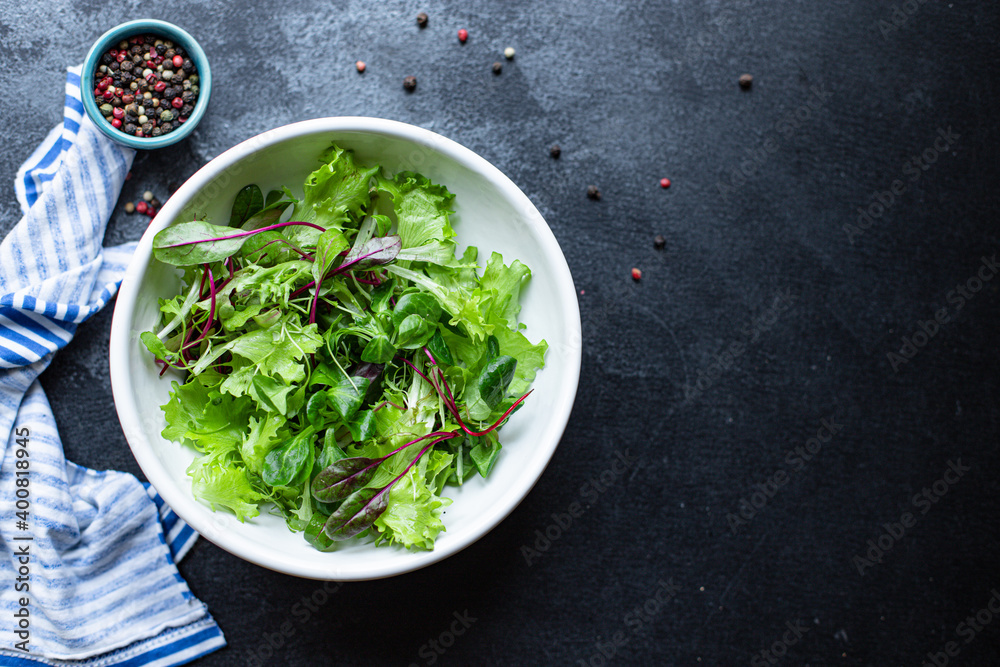 salad green mix leaves vitamins ready to cook and eat on the table for making healthy meal snack top view copy space for text food background rustic image keto or paleo diet salad green mix leaves vitamins ready to cook and eat on the table for making healthy meal snack top view copy space for text food background rustic image keto or paleo diet
