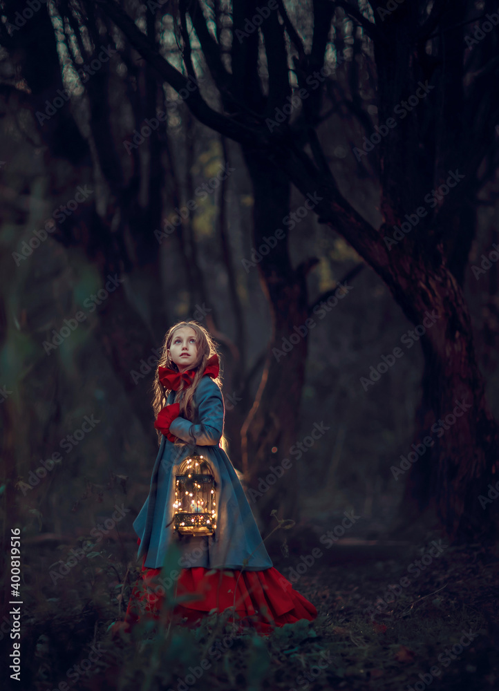 Girl with cage and bird in the night autumn forest