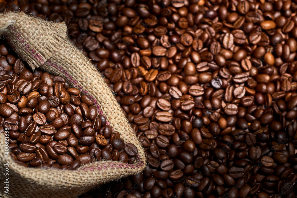 Fototapeta premium Studio Shot of Coffee and Burlap Bag with Coffee over coffee beans