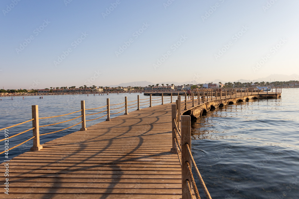 Hurghada, Egypt - September 28 2020: View of the wooden boardwalk over the Red Sea during sunset in Hurghada, Egypt