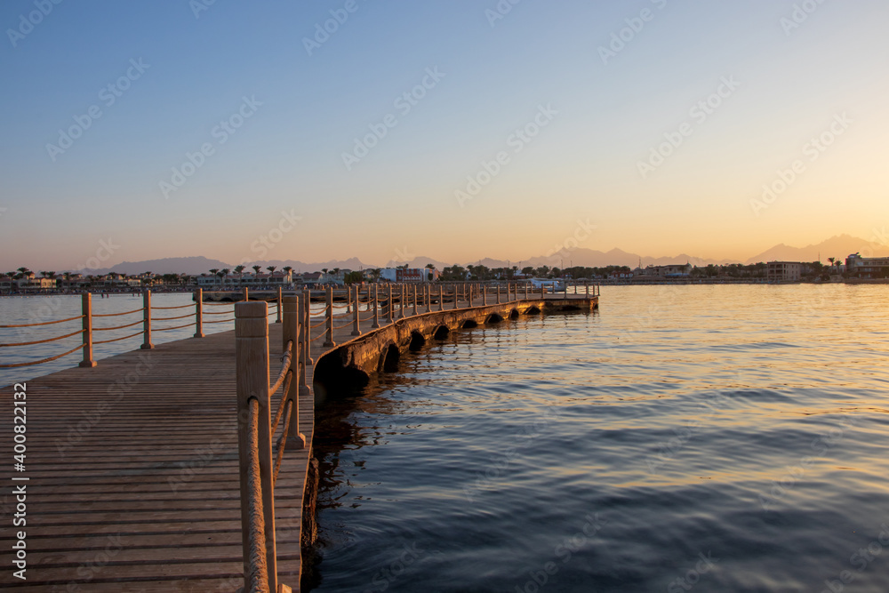 Hurghada, Egypt - September 28 2020: View of the wooden boardwalk over the Red Sea during sunset in Hurghada, Egypt