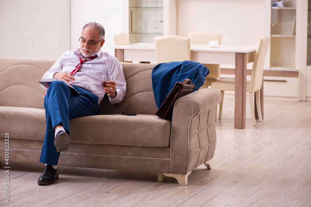 Fototapeta premium Old male boss employee coming home from work