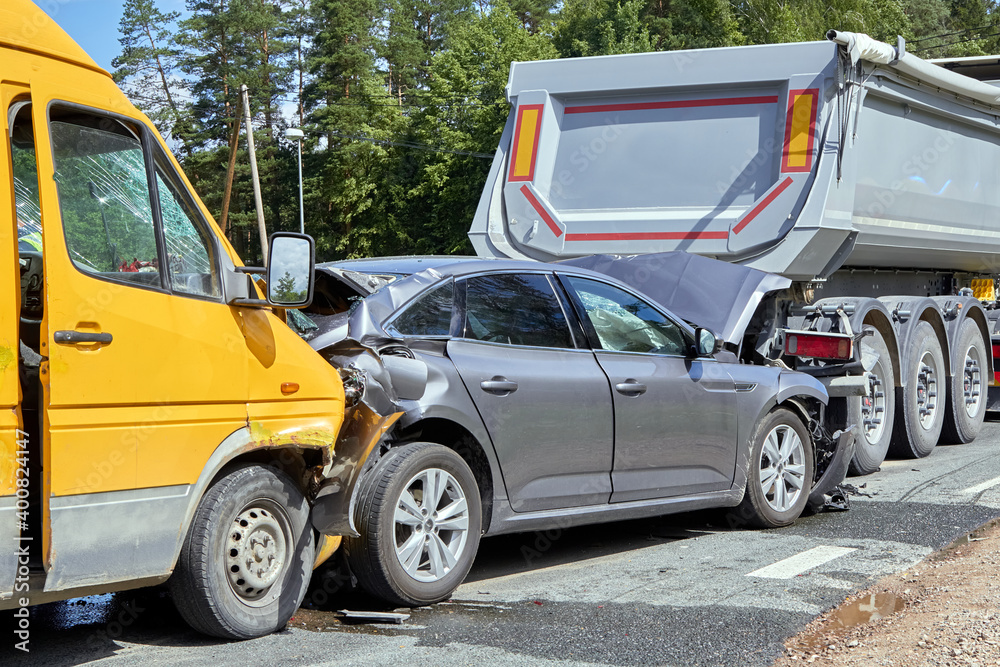 damaged cars on the highway at the scene of an accident
