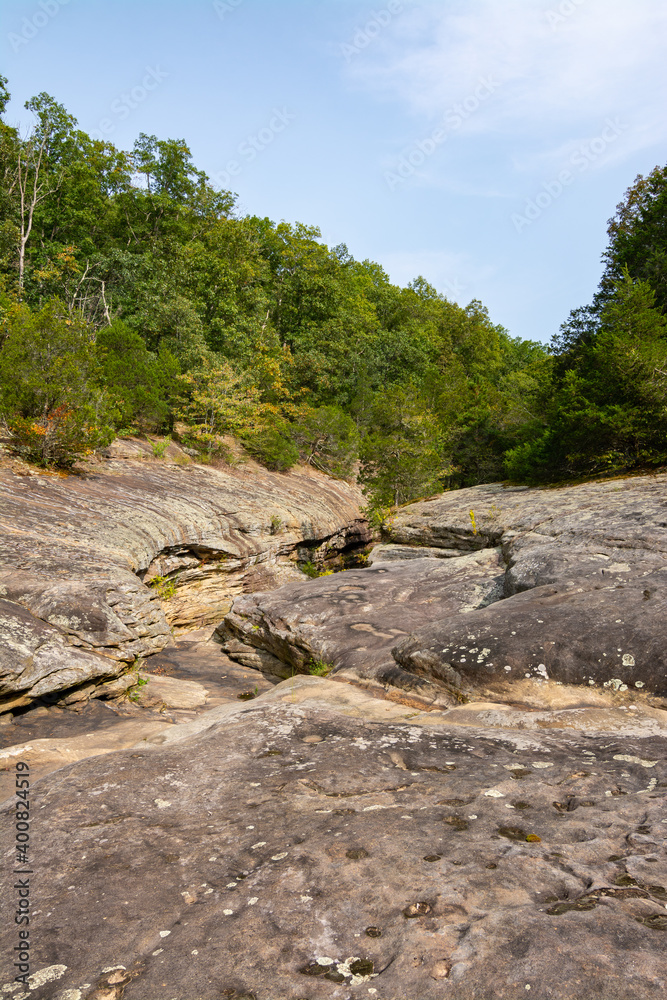 Barren rock formations and small creek run between the trees in the Bell Smith Springs area of the Shawnee National Forest. Barren rock formations and small creek run between the trees in the Bell Smith Springs area of the Shawnee National Forest.