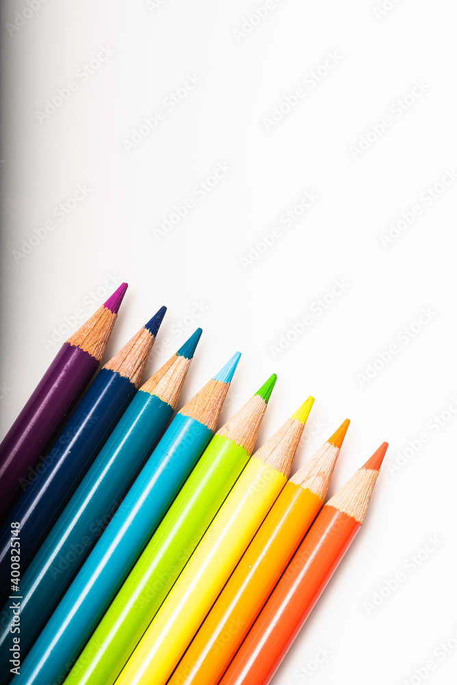 Rainbow of colored pencils lined up against a white background Rainbow of colored pencils lined up against a white background