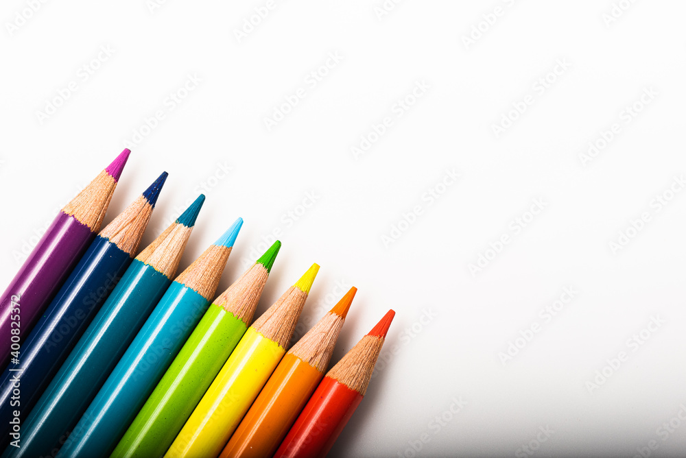 Rainbow of colored pencils lined up against a white background Rainbow of colored pencils lined up against a white background