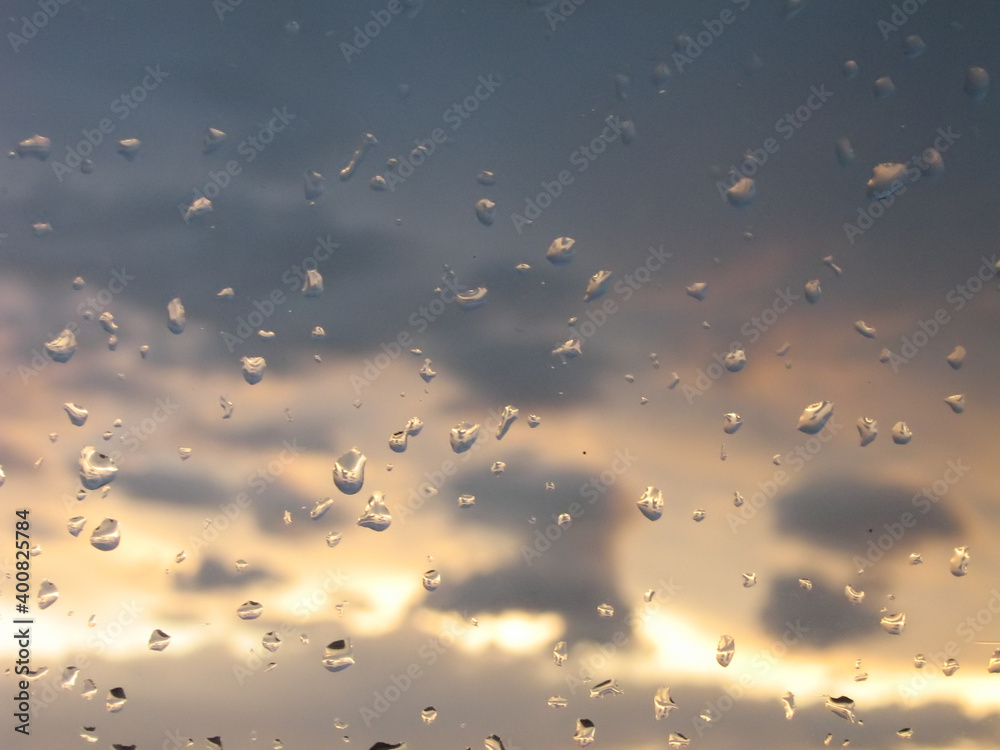 Glass water drops defocused sunset sunrise background