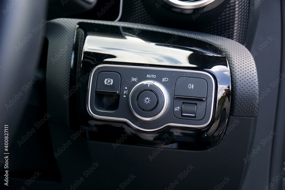 Light controls panel and electronic handbrake switch on a modern car