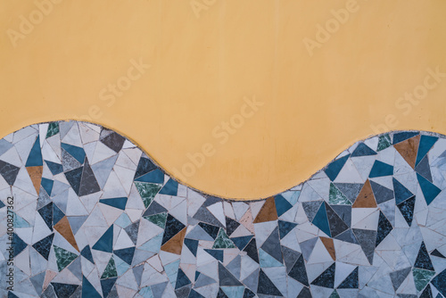 Wall decorated with ornamental waves of broken tile mosaics