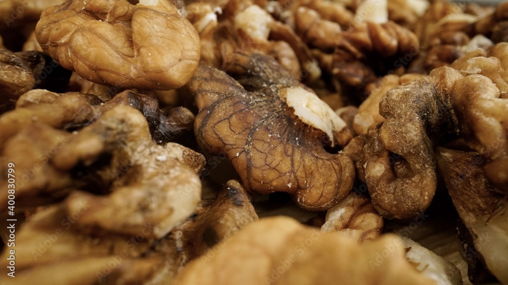 Heap of raw walnuts close-up as background. Walnuts close-up.Walnuts as background. Heap of raw walnuts close-up as background. Walnuts close-up.Walnuts as background.