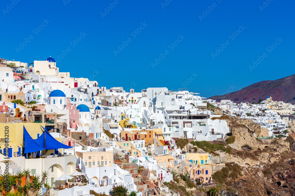 Fototapeta premium Oia village, the most picturesque village on Santorini island, a famous touristic resort in the Cyclades islands, Aegean sea, Greece, Europe