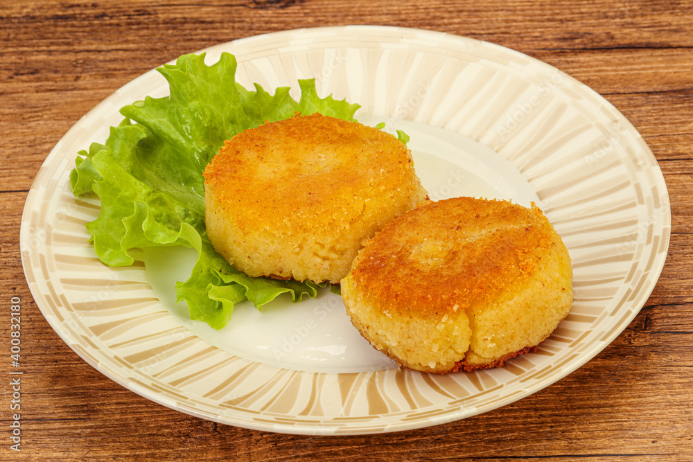 Vegan cuisine - Potato cutlet in the plate Vegan cuisine - Potato cutlet in the plate