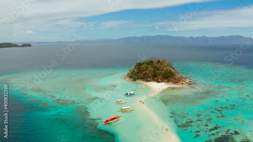 aerial seascape tropical island and sand beach, turquoise water and coral reef. malacory island, Philippines, Palawan. tourist boats on coast tropical island.