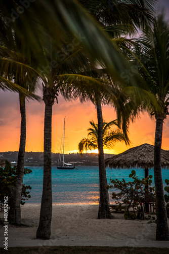 sunset on the beach with sailboat