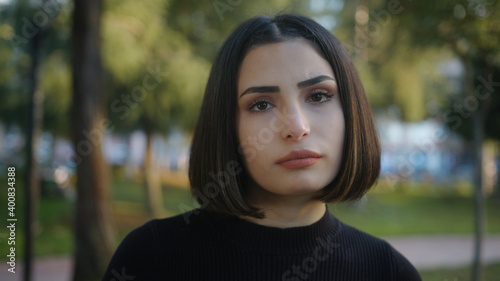 Young attractive woman taking a bored demeanor looking at the camera