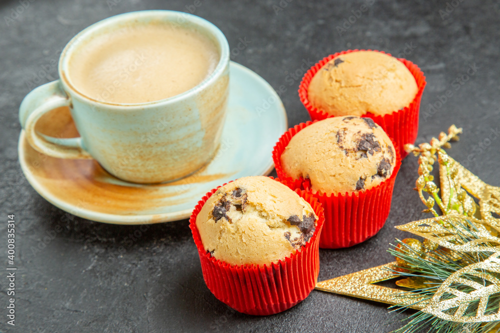 Front close view of delicious coffee small cupcakes on dark background Front close view of delicious coffee small cupcakes on dark background