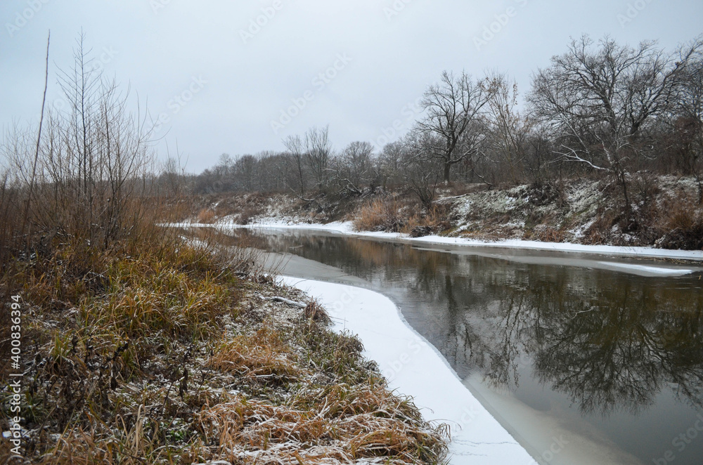 River landscape in winter, riverbank covered with snow and frost. Cold winter day. Northern nature. River landscape in winter, riverbank covered with snow and frost. Cold winter day. Northern nature.