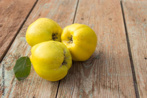 Quince, yellow ripe apple quince on wooden background