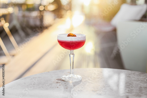 Wallpaper Mural A red sour cocktail on a marble table on a sunny terrace Torontodigital.ca