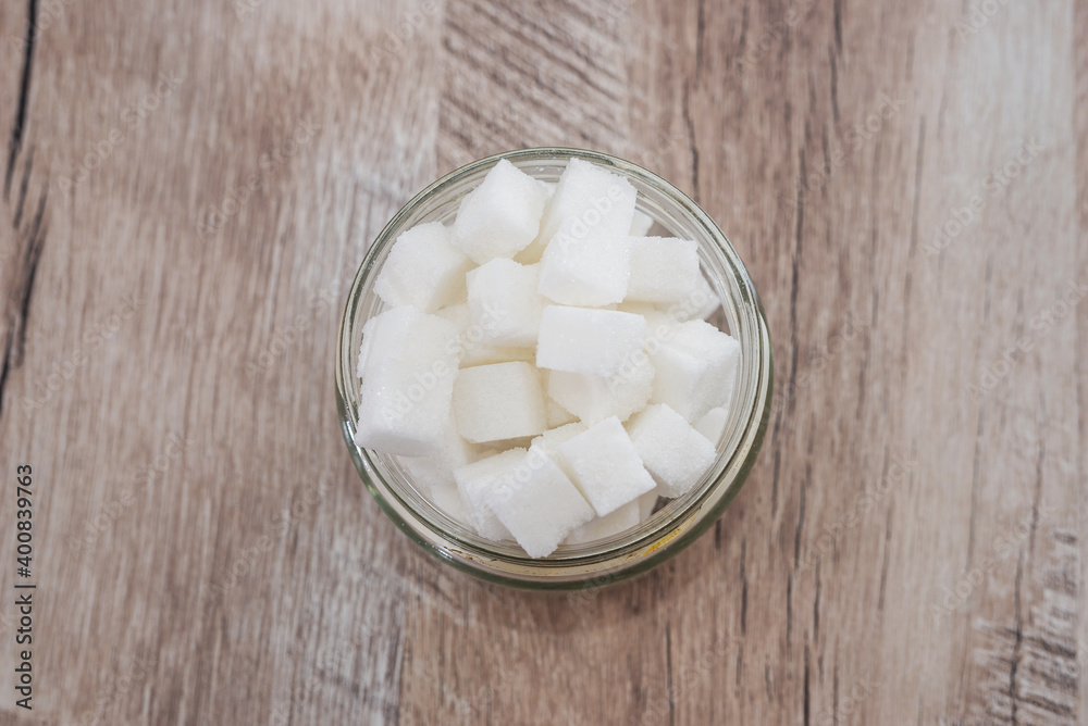 sugar cubes in a jar on a wooden background. View from above. sugar cubes in a jar on a wooden background. View from above.
